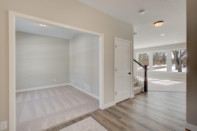 8683 Peony Ln N, Maple Grove, MN 55311 - unfurnished room with stairs, wood finished floors, baseboards, and a smoke detector