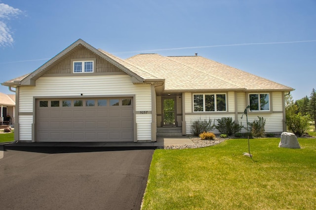 5057 Linden Trl N, Lake Elmo, MN 55042 - view of front of property featuring asphalt driveway, a front lawn, a garage, and a shingled roof