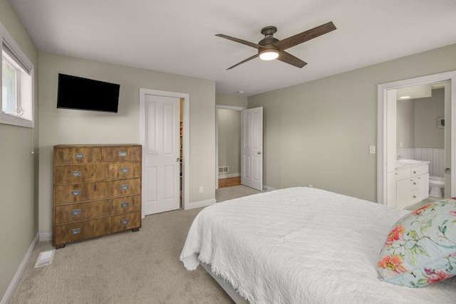 5057 Linden Trl N, Lake Elmo, MN 55042 - bedroom with light carpet, baseboards, ensuite bathroom, and ceiling fan