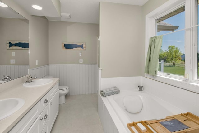 5057 Linden Trl N, Lake Elmo, MN 55042 - full bath with a wainscoted wall, a garden tub, toilet, and double vanity