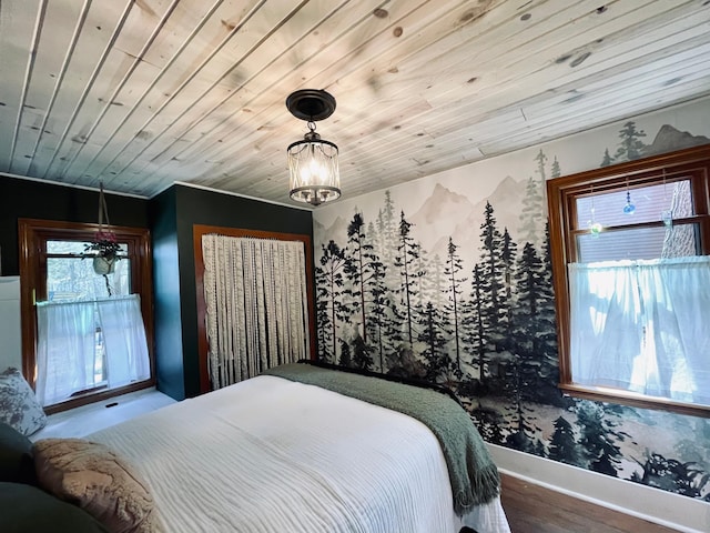 506 2nd St S, Tower, MN 55790 - bedroom with baseboards, wood finished floors, a chandelier, and wood ceiling