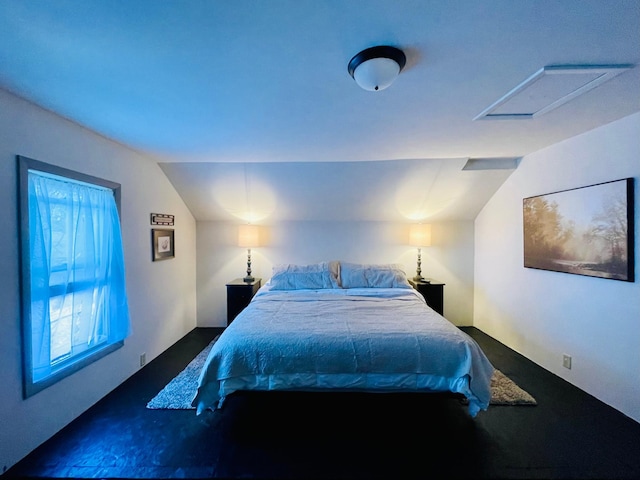 506 2nd St S, Tower, MN 55790 - bedroom featuring vaulted ceiling, dark colored carpet, and attic access