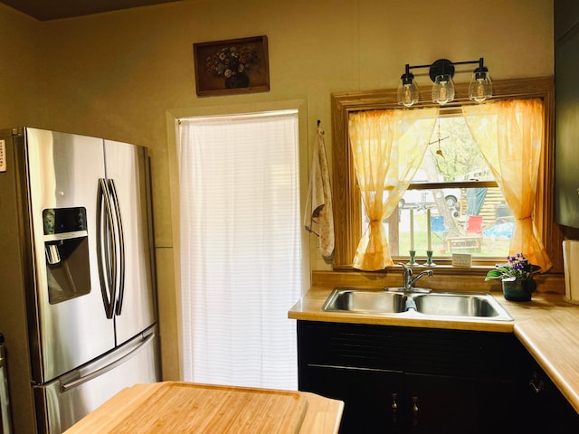 506 2nd St S, Tower, MN 55790 - kitchen featuring stainless steel fridge with ice dispenser, a sink, and dark cabinets