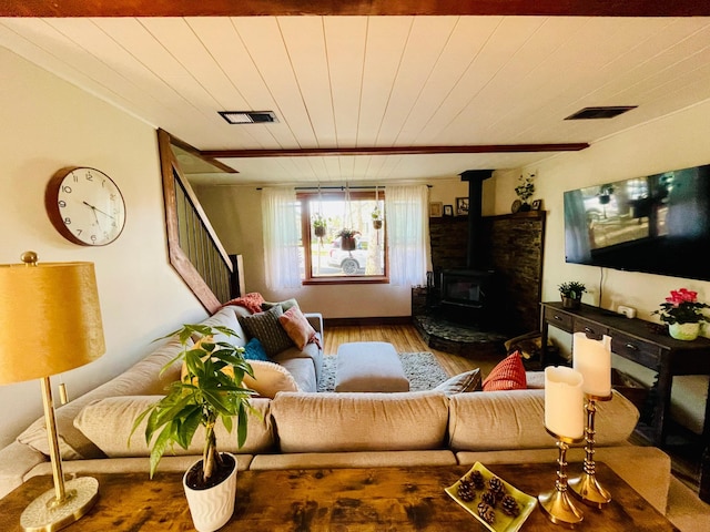 506 2nd St S, Tower, MN 55790 - living room featuring wood finished floors, wood ceiling, a wood stove, and stairs