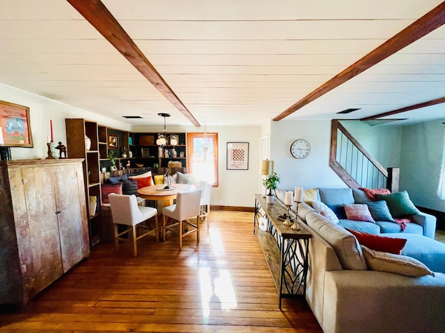 506 2nd St S, Tower, MN 55790 - living room featuring hardwood / wood-style floors, stairs, a chandelier, and wood ceiling with exposed beams