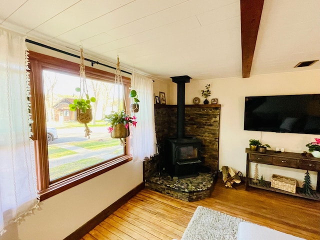 506 2nd St S, Tower, MN 55790 - living area featuring wood finished floors, a wood stove, and baseboards