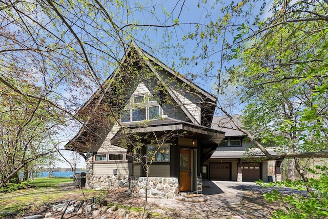 view of front of house with stone siding and an attached garage
