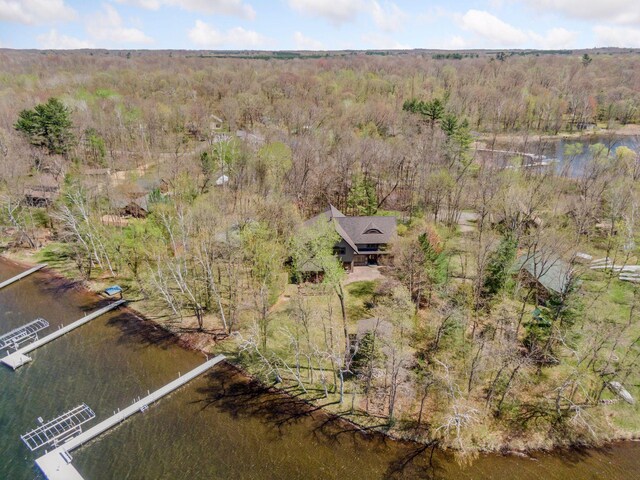 view from above of property featuring a forest and a nearby body of water