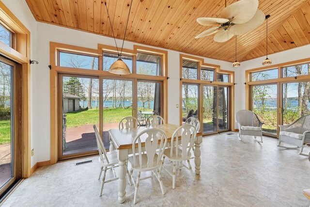 dining space with plenty of natural light, wooden ceiling, baseboards, and a ceiling fan