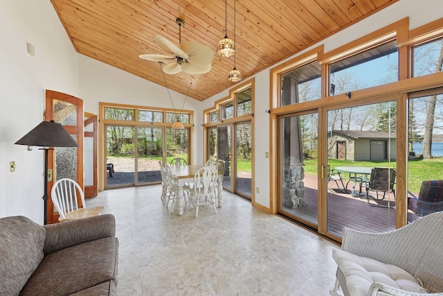 sunroom / solarium with wooden ceiling, high vaulted ceiling, and baseboards