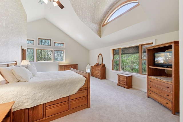 bedroom with lofted ceiling, multiple windows, light colored carpet, ceiling fan, and baseboards