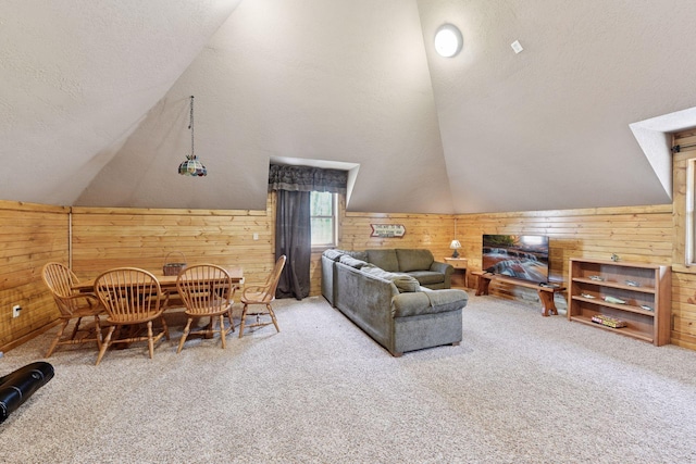 carpeted living room with wood walls, lofted ceiling, and a textured ceiling