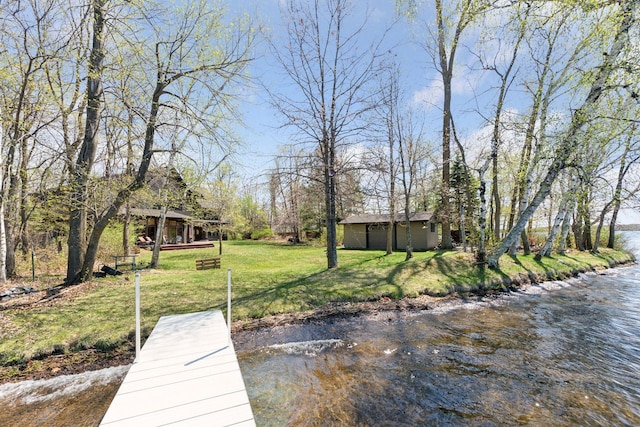 dock area with a lawn and a water view
