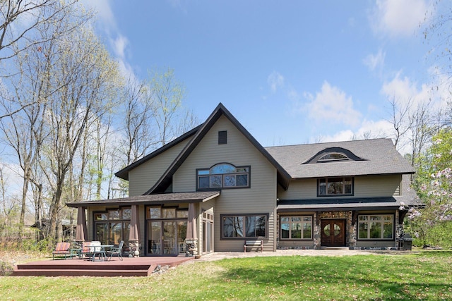 2273 Woodland Shrs Unit A, Luck, WI 54853 - rear view of property featuring a wooden deck, a lawn, french doors, and a shingled roof