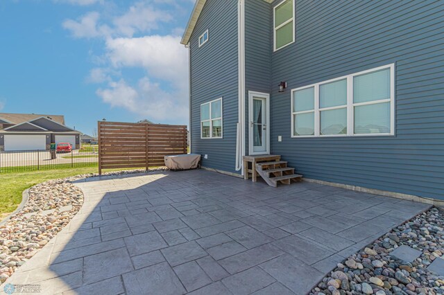 view of patio with entry steps and fence
