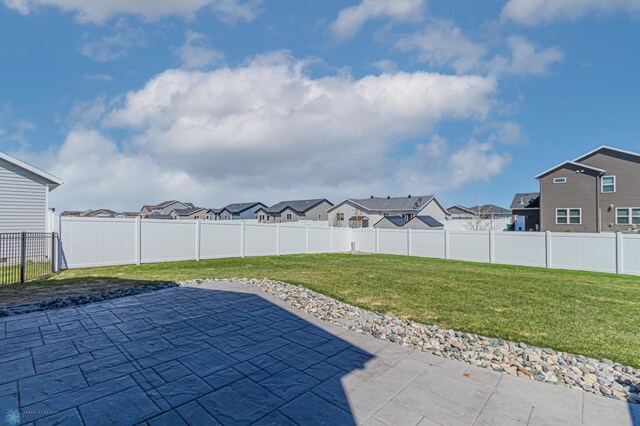 view of yard featuring a residential view and a patio area