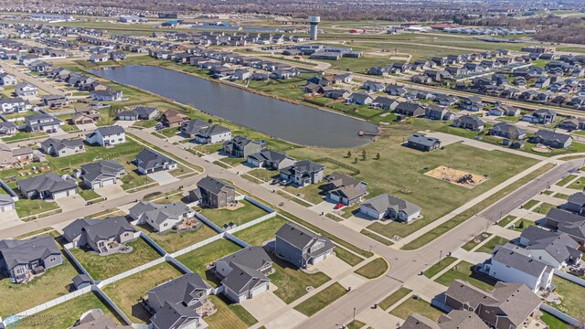 view of property location featuring a large body of water and nearby suburban area