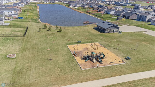 aerial overview of property's location with a large body of water, nearby suburban area, and a recreational park