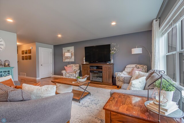 living area featuring baseboards and recessed lighting