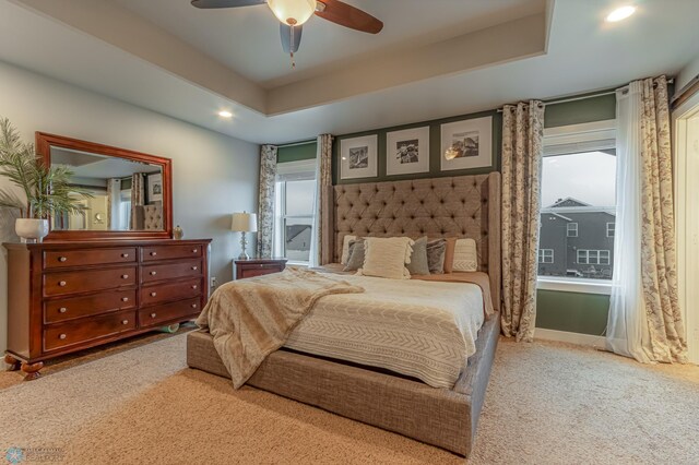 carpeted bedroom featuring recessed lighting, ceiling fan, a tray ceiling, and baseboards