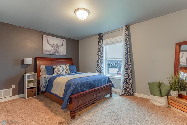 bedroom featuring baseboards and carpet