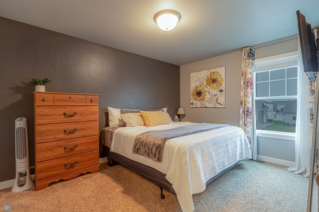 carpeted bedroom with baseboards