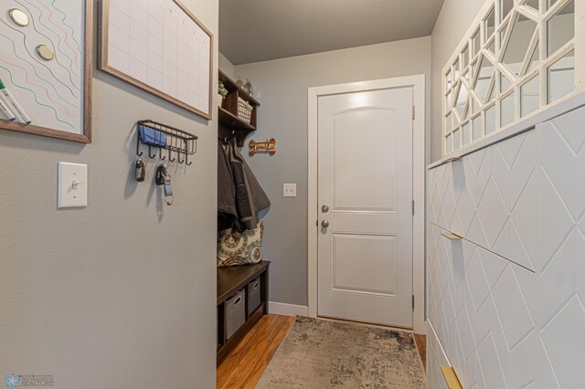 mudroom with light wood-style flooring and baseboards