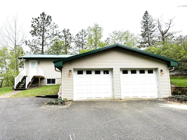 23479 State 200, Itasca Twp, MN 56676 - view of property exterior with driveway and a garage
