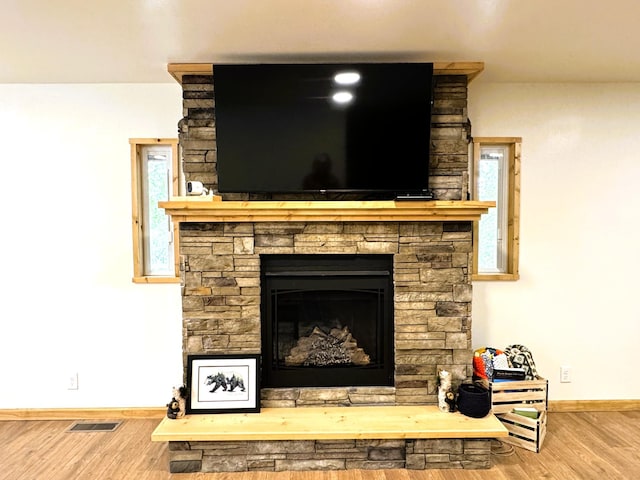 23479 State 200, Itasca Twp, MN 56676 - detailed view of wood finished floors, baseboards, and a fireplace