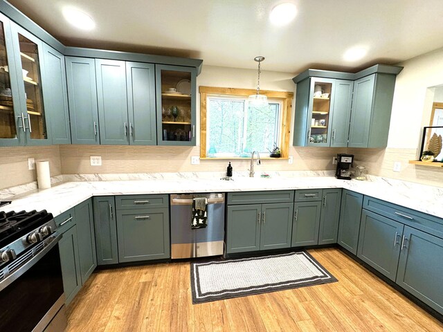 23479 State 200, Itasca Twp, MN 56676 - kitchen with stainless steel appliances, pendant lighting, light wood-style flooring, decorative backsplash, and recessed lighting