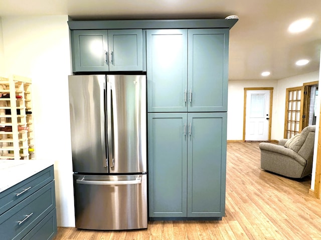 23479 State 200, Itasca Twp, MN 56676 - kitchen featuring freestanding refrigerator, recessed lighting, light wood finished floors, and open floor plan