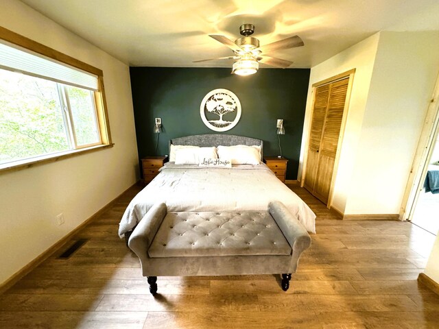 23479 State 200, Itasca Twp, MN 56676 - bedroom with wood finished floors, a closet, and baseboards