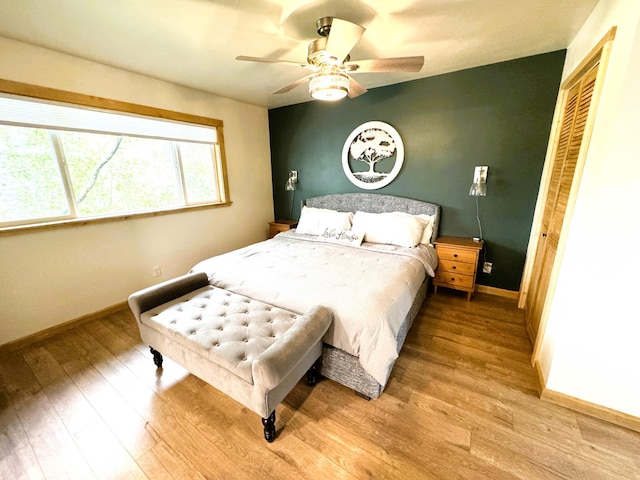23479 State 200, Itasca Twp, MN 56676 - bedroom featuring wood finished floors, baseboards, a closet, and a ceiling fan