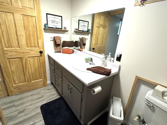 23479 State 200, Itasca Twp, MN 56676 - bathroom with toilet, vanity, and wood finished floors