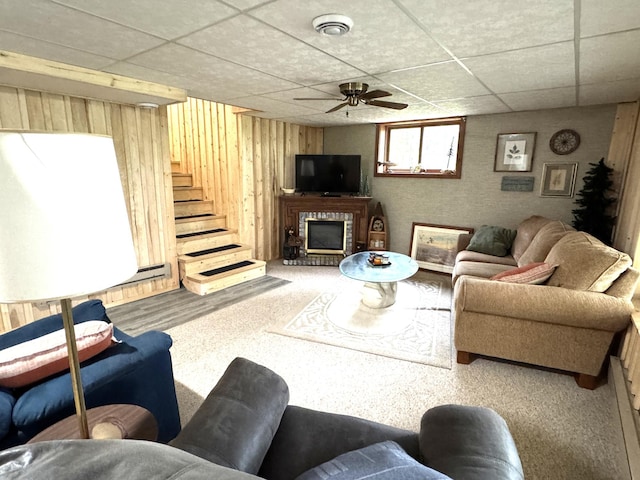 23479 State 200, Itasca Twp, MN 56676 - living room with a paneled ceiling, stairs, wooden walls, carpet floors, and a fireplace