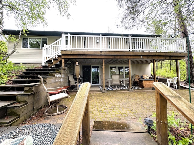 23479 State 200, Itasca Twp, MN 56676 - rear view of house featuring stairs, a wooden deck, and a patio area
