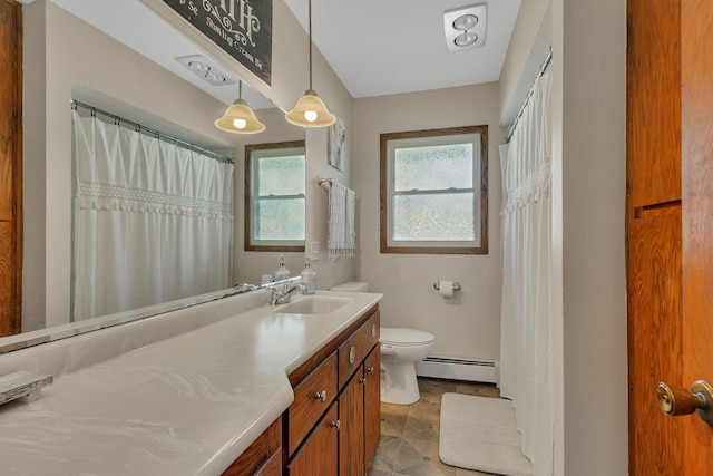 bathroom featuring baseboard heating, toilet, and vanity