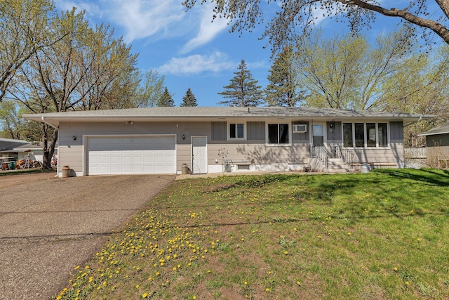 ranch-style home featuring concrete driveway, a garage, and a front yard