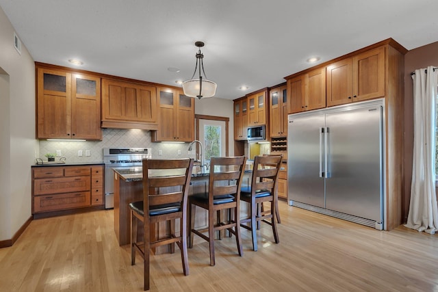 1901 11th St N, Sartell, MN 56377 - kitchen with built in appliances, brown cabinets, light wood-type flooring, and recessed lighting