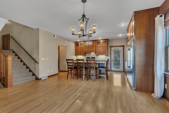 1901 11th St N, Sartell, MN 56377 - dining room with a chandelier, light wood-style floors, baseboards, recessed lighting, and stairs