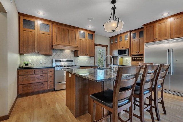 1901 11th St N, Sartell, MN 56377 - kitchen featuring built in appliances, a sink, brown cabinetry, light wood-style floors, and recessed lighting