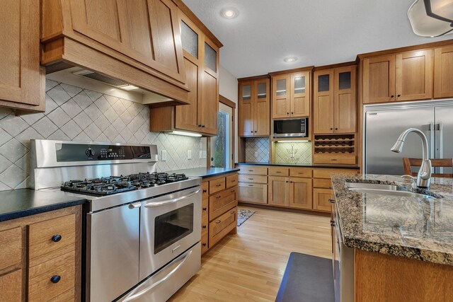 1901 11th St N, Sartell, MN 56377 - kitchen with built in appliances, a sink, light wood-type flooring, brown cabinets, and recessed lighting