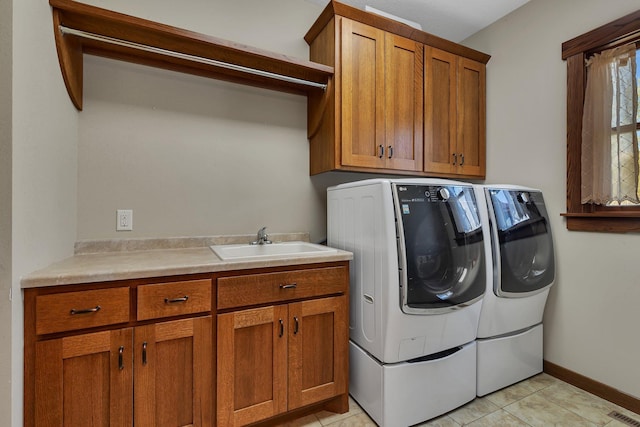 1901 11th St N, Sartell, MN 56377 - laundry area featuring independent washer and dryer, cabinet space, light tile patterned floors, and baseboards
