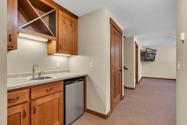 1901 11th St N, Sartell, MN 56377 - kitchen with refrigerator, brown cabinetry, light colored carpet, light countertops, and baseboards