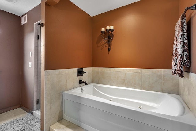 1901 11th St N, Sartell, MN 56377 - full bath with tile patterned floors, a tub with jets, a stall shower, and tile walls