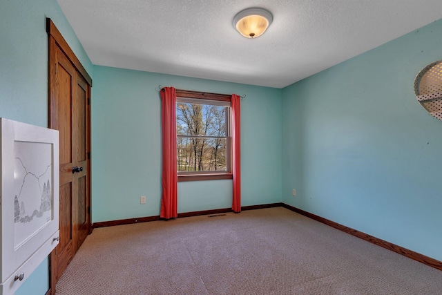 1901 11th St N, Sartell, MN 56377 - carpeted empty room featuring baseboards and a textured ceiling