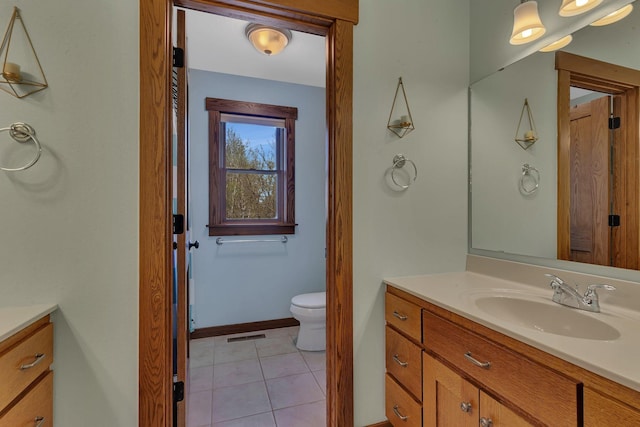 1901 11th St N, Sartell, MN 56377 - bathroom with vanity, toilet, tile patterned flooring, and baseboards