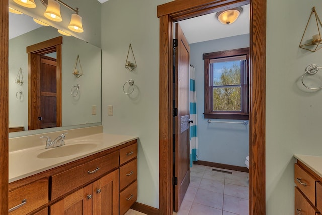 1901 11th St N, Sartell, MN 56377 - full bath with vanity, baseboards, tile patterned floors, and toilet