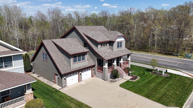 1901 11th St N, Sartell, MN 56377 - view of front of property featuring driveway, a garage, roof with shingles, and a front lawn