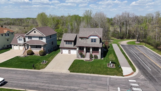 1901 11th St N, Sartell, MN 56377 - view of front of house featuring driveway, covered porch, an attached garage, and a front yard